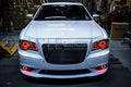 Front end of a Chrysler with red LED headlight and fog light halo rings.