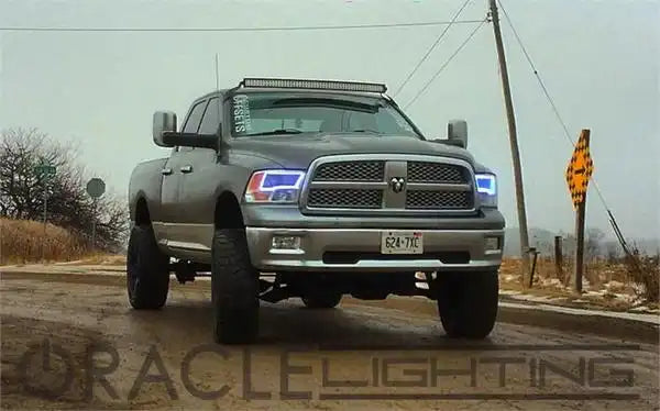 Three quarters view of a Dodge Ram with white LED halo rings installed.