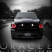 Front view of a black Dodge Ram with red LED headlight halo rings installed.