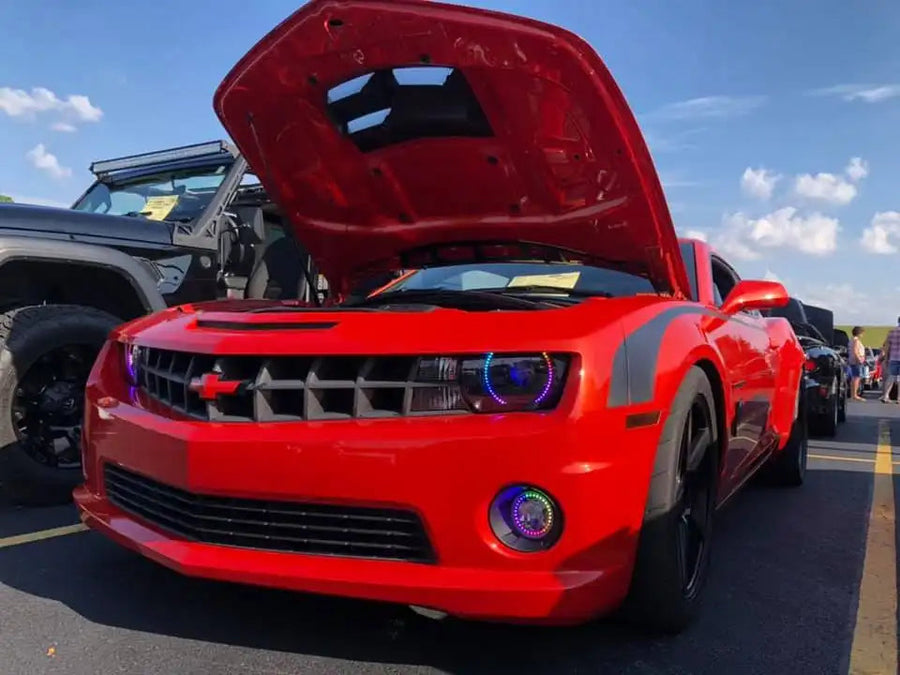 Red camaro with hood open and dynamic colorshift halo headlights and fog lights