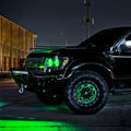 Black and green Ford Raptor with green LED lighting installed.