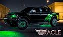 Black and green Ford Raptor with green LED lighting installed.