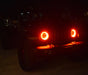 Jeep at night with red headlight halos on.