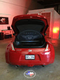 Rear end of a Nissan 370Z with GOBO Projectors installed, showing the Texas flag.