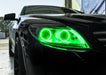 Close-up on the headlight of a Mercedes Benz CL 500 with green LED halo rings.