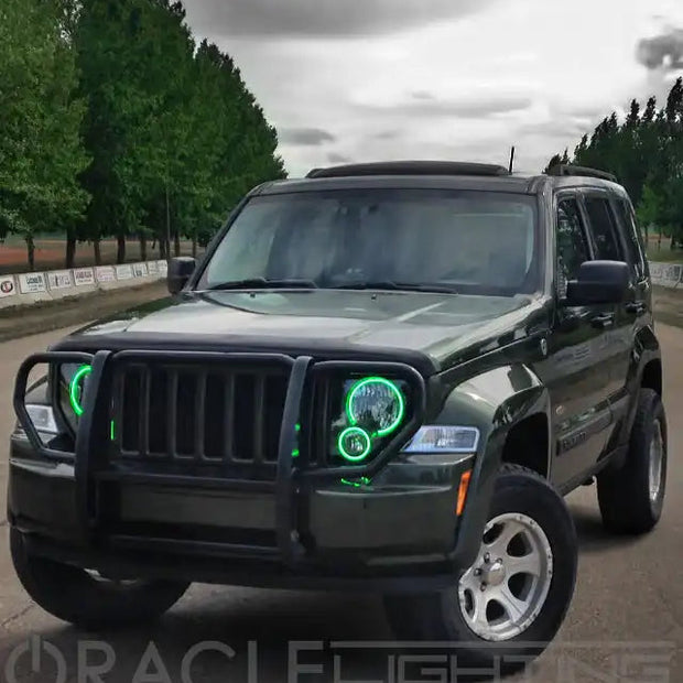 Three quarters view of a Jeep Liberty with green LED headlight halo rings installed.