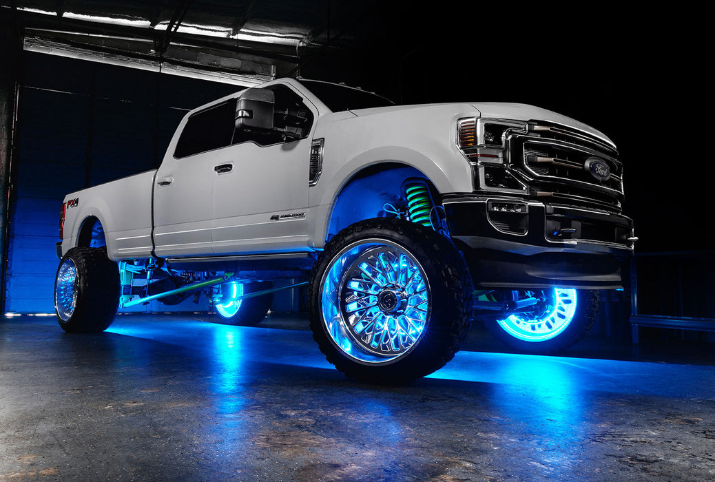 White Ford Superduty with cyan LED wheel rings.