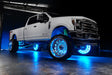 White Ford Superduty with cyan LED wheel rings.