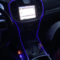 Close-up of blue fiber optic lighting installed on the console of a vehicle.