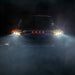 Front view of a Toyota truck in a dark, foggy environment