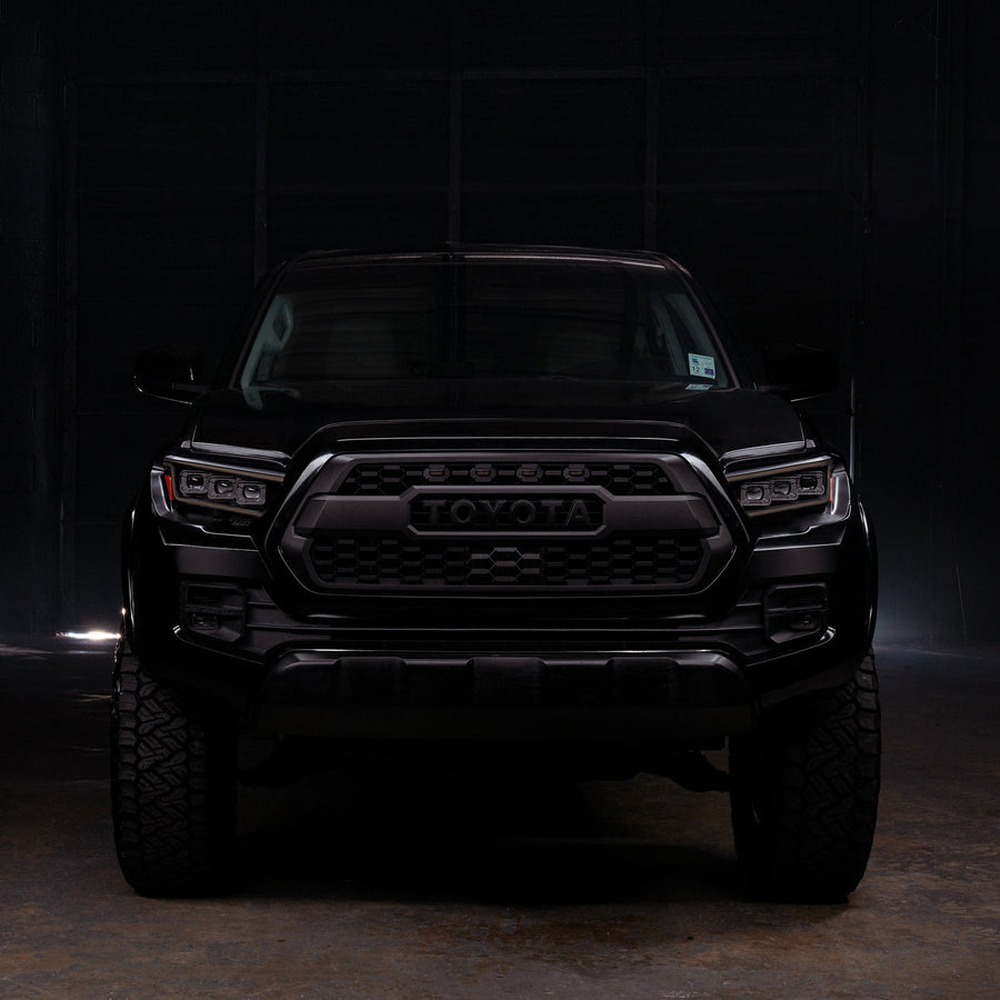 Black Toyota truck in a dark setting