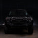 Black Toyota truck in a dark setting