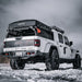 Rear three quarters view of a white Jeep Gladiator in the snow with Flush Mount LED Tail Lights installed.