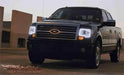 Three quarters view of a Ford F-150 with white LED headlight halos.