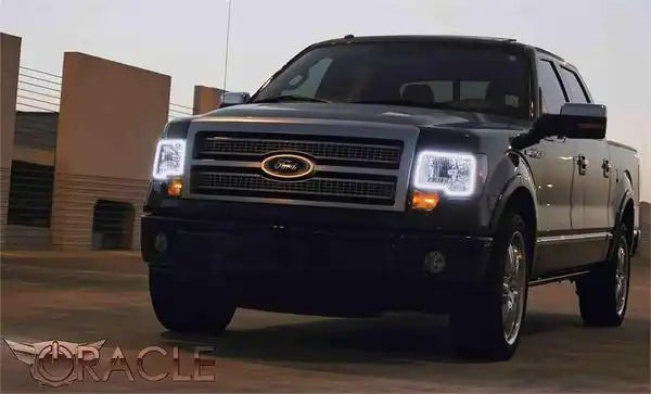 Three quarters view of a Ford F-150 with white LED headlight halos.