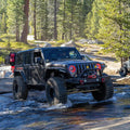 Jeep outdoors in the water with bright red halo headlights