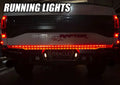 Rear end of a Ford Raptor with 60" Double Row LED Truck Tailgate Light Bar installed and running lights on.