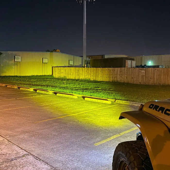 View from the driver's side of a Jeep, showing the light beam from the LED Integrated Skit Plate shining into the distance.