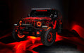 Red Jeep with multiple ORACLE Lighting products installed, including Oculus Headlights, fog light halo kit, and LED illuminated wheel rings.