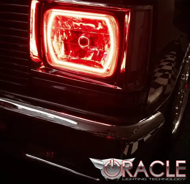 Close-up of Sealed Beam 7x6 H6054 Headlight with Pre-Installed SMD Halo installed on a car, with red halos.