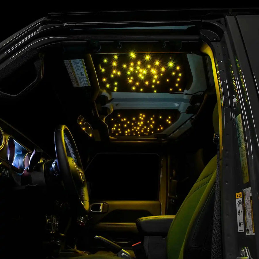 Jeep interior with StarLINER Fiber Optic Hardtop Headliner installed on the roof panels, set to yellow LEDs.