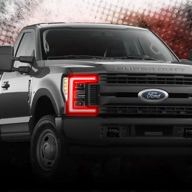 Three quarters view of Ford Superduty with red headlight DRLs