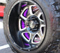 Close up of a wheel with purple LED wheel rings.