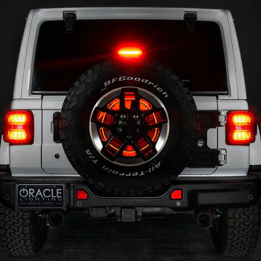 Rear end of a white Jeep with LED Illuminated Spare Tire Wheel Ring Third Brake Light installed.