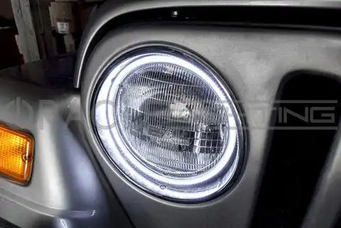Close-up of white LED halo ring installed on a Jeep.