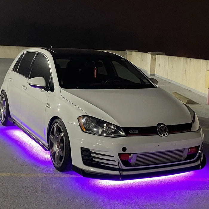 White Volkswagen on a rooftop garage with purple LED underbody kit.