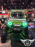 Polaris RZR in a showroom, equipped with green LED headlight halos.