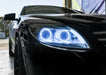 Close-up on the headlight of a Mercedes Benz CL 500 with white LED halo rings.