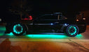 Side view of black Camaro with LED wheel rings and LED underbody kit installed.