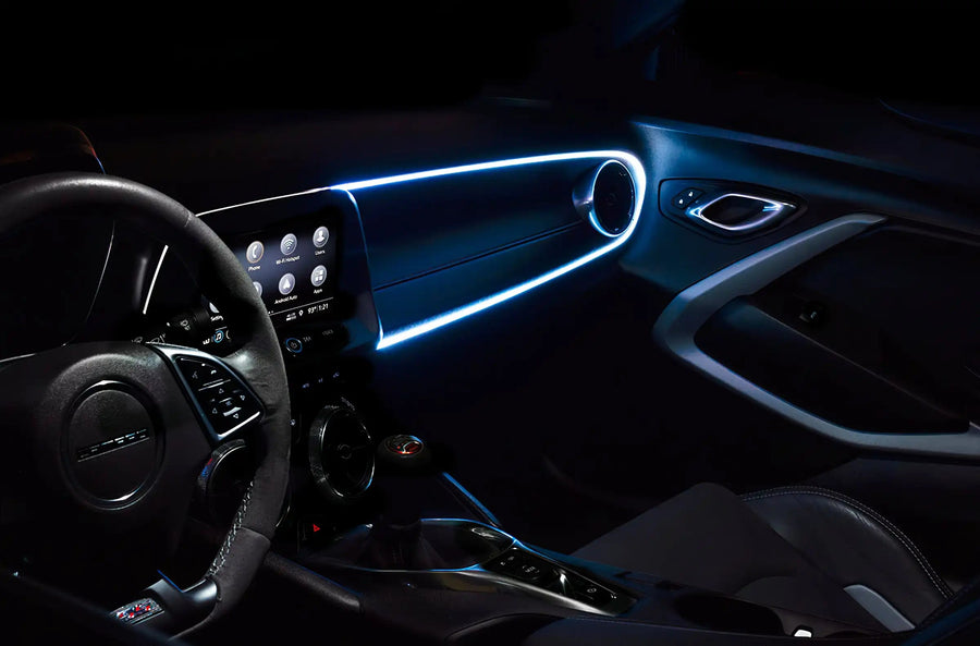 Car interior with white fiber optic lighting installed on the dashboard.