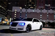 Three quarters view of a Chrysler with blue LED headlight halo rings installed.