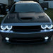 Front end of a silver Dodge Challenger with white LED headlight and fog light halo rings installed.