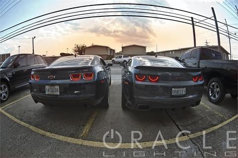 2 Chevrolet Camaros side by side in a parking lot, both with afterburner tail light halos installed