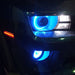 Close-up of blue LED headlight and fog light halo rings installed on a Chevrolet Camaro.