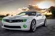 Lifestyle image of white camaro with green halo headlights and fog lights
