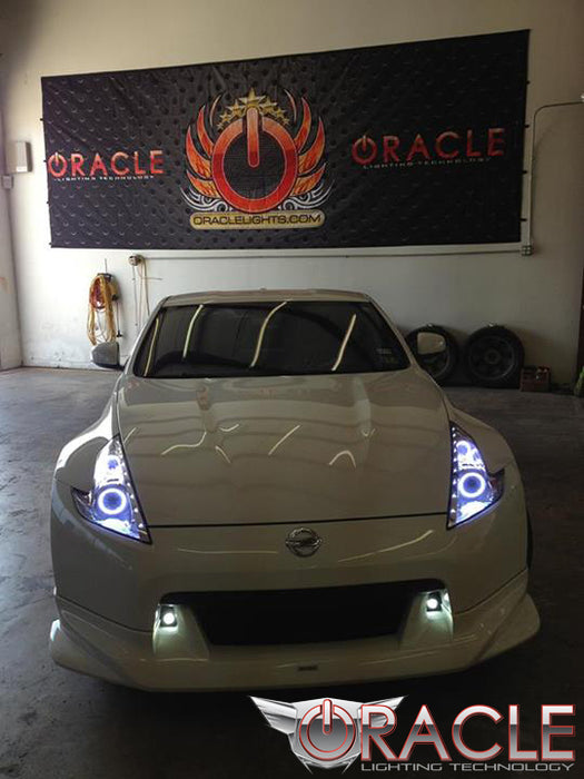 Front end of a Nissan 370Z with white LED headlight halo rings installed.