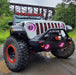Front end of a Jeep with ColorSHIFT Oculus Headlights installed, with pink halo rings.