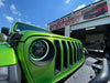 Close-up on a ColorSHIFT Oculus Headlight installed on a Jeep, with green halos on.