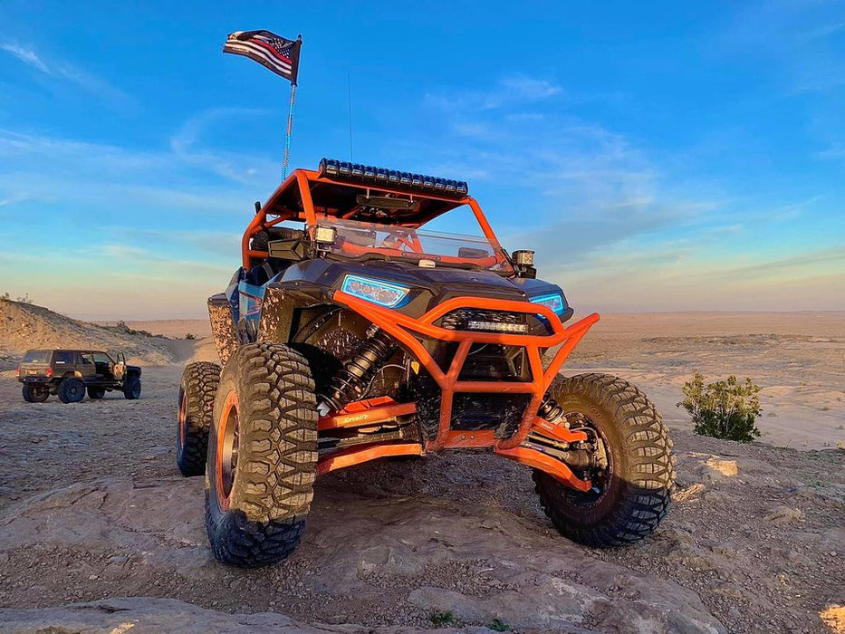 Action shot of polaris RZR off-roading with blue halos