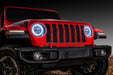 Front end of a red Jeep with white headlight DRLs.