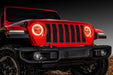 Front end of a red Jeep Wrangler JL with amber headlight DRLs on.