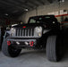 Front end of a Jeep Wrangler with white LED headlight and fog light halos installed.