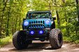 Front end of a Jeep Wrangler JK with blue LED headlight and fog light halos installed.