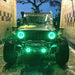 Front end of a Jeep Wrangler JK with green LED headlight and fog light halos installed.