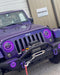 Front end of a Jeep Wrangler JK with purple LED headlight and fog light halos installed.