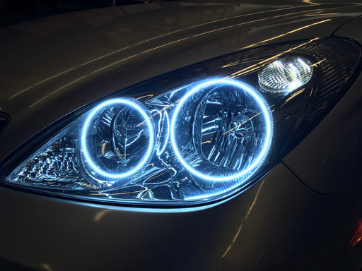 Close-up of a Lexus ES 300 headlight with white halos.